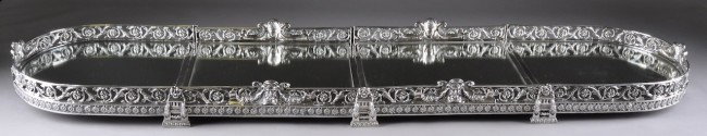 AN ANTIQUE FRENCH SILVER PLATED SURTOUT DE TABLE, : AN ANTIQUE FRENCH SILVER PLATED SURTOUT DE TABLE, 19TH CENTURY, the four sectioned mirrored plateau of rounded rectangular form with pierced chased and repousse gallery of scrolling foliage and altern