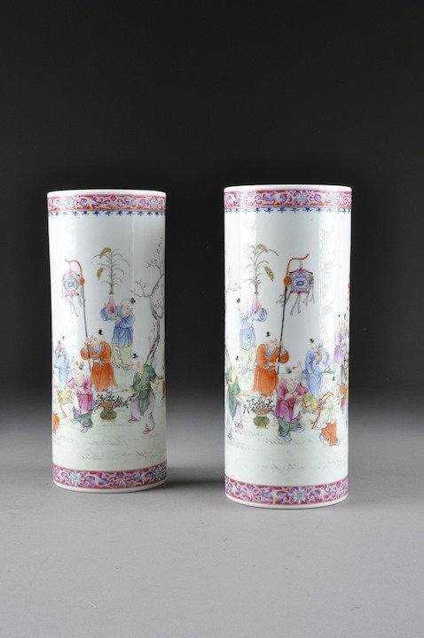 A PAIR OF VINTAGE CHINESE FAMILLE ROSE HAT STANDS,: A PAIR OF VINTAGE CHINESE FAMILLE ROSE HAT STANDS, EARLY 20TH CENTURY, each of crylindrical form and colorfully enameled with boys at various pursuits in an outdoor setting. Bearing red six character 