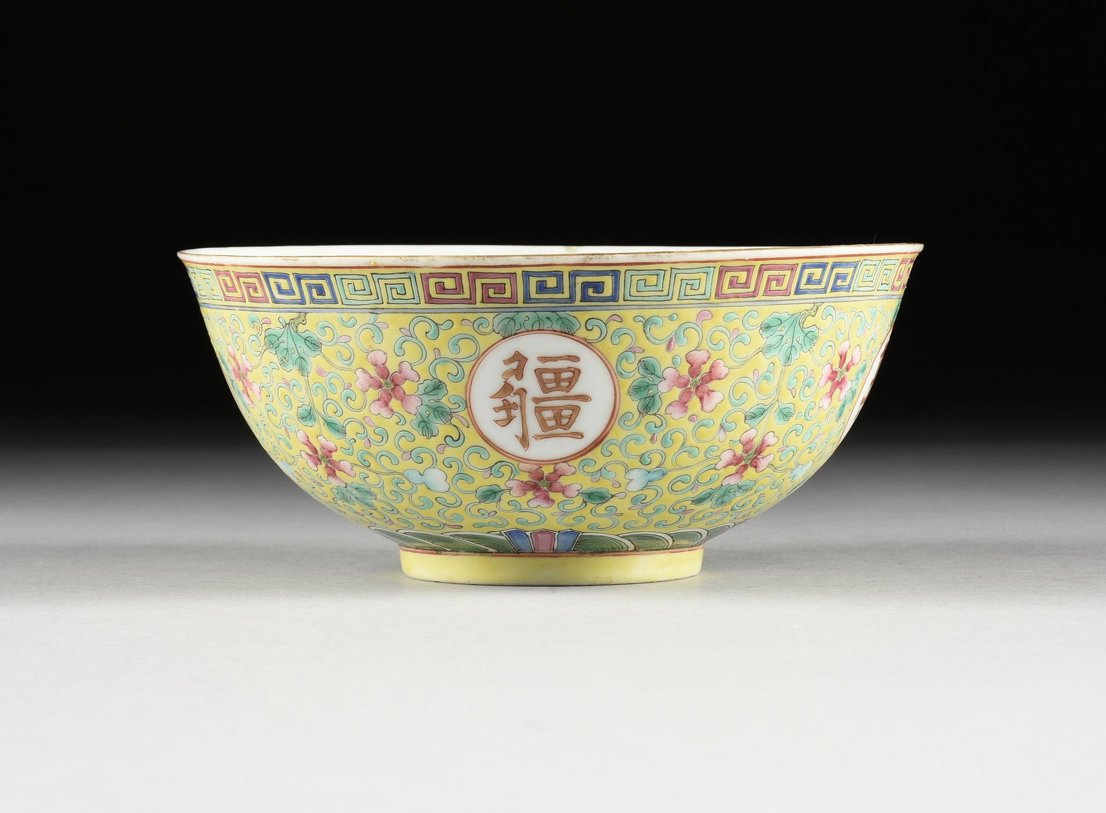 A CHINESE YELLOW GROUND ENAMELED PORCELAIN 'BLESSINGS' BOWL, GUANGXU PERIOD, 1875-1908,: A CHINESE YELLOW GROUND ENAMELED PORCELAIN 'BLESSINGS' BOWL, GUANGXU PERIOD, 1875-1908, the bowl with slightly everted rim centers a good luck symbol surrounded by five auspicious bats in orange and g