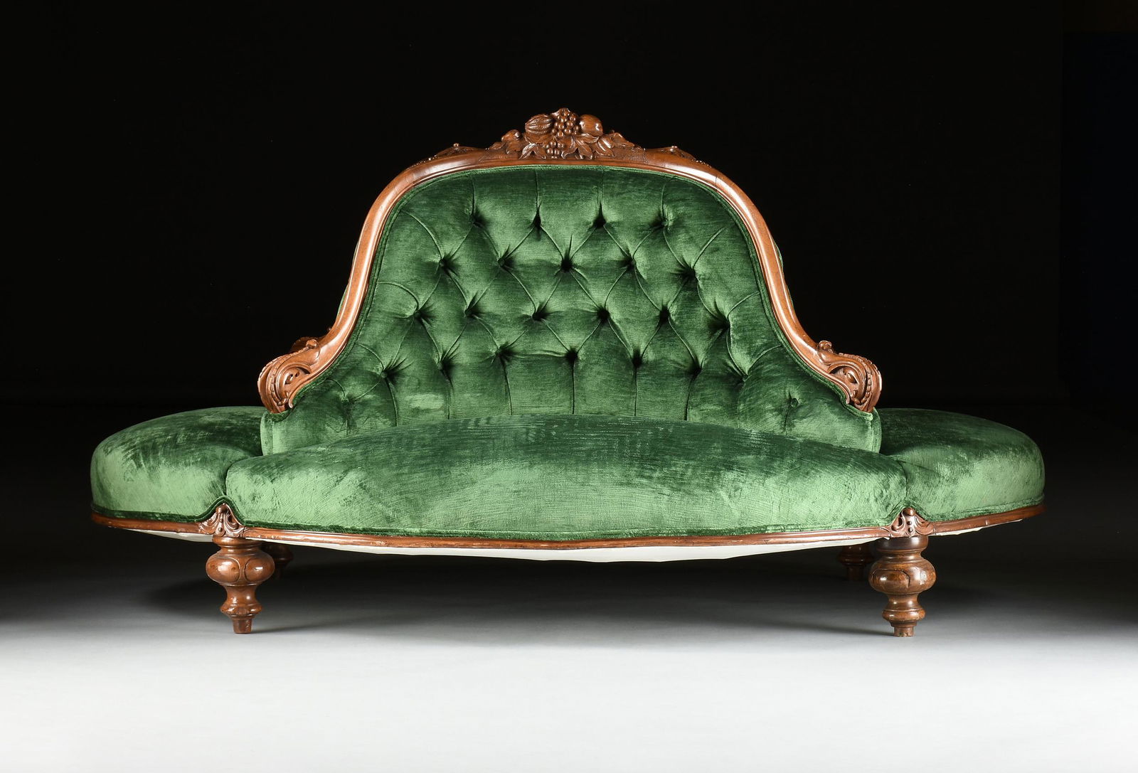 A VICTORIAN GREEN VELVET UPHOLSTERED AND CARVED WALNUT CONFIDANTE, MID 19TH CENTURY, (1 of 5)