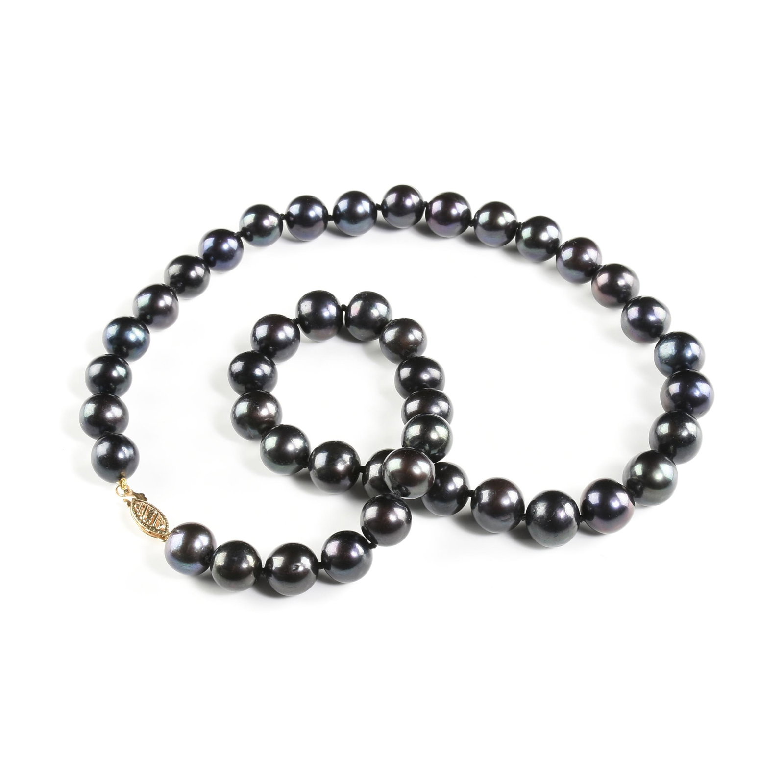 A 14K YELLOW ROLLED GOLD AND BLACK TAHITIAN STYLE PEARL NECKLACE, MODERN,: A 14K YELLOW ROLLED GOLD AND BLACK TAHITIAN STYLE PEARL NECKLACE, MODERN, a strand of forty-three 9.2-10.6mm round to near round black pearls, having some dark green and eggplant tones, silk knotted w
