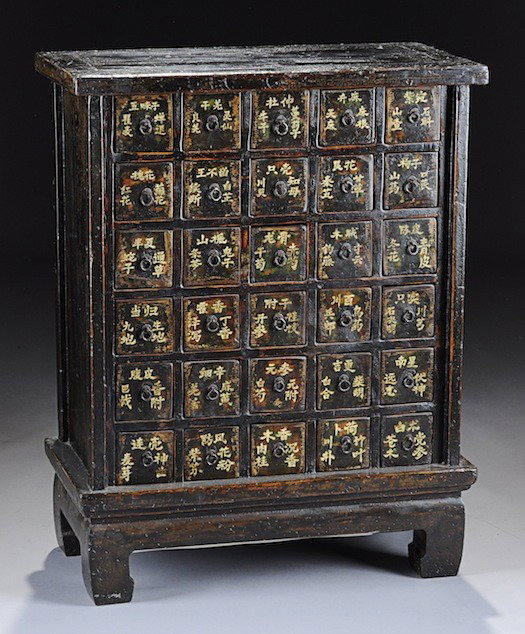 A CHINESE LACQUERED AND PAINTED WOOD APOTHECARY CA: A CHINESE LACQUERED AND PAINTED WOOD APOTHECARY CABINET, 19TH CENTURY, of rectangular form and enclosing rows of short deep drawers with white painted Chinese characters on a tapering plinth and raise