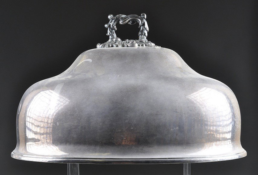 A LARGE VICTORIAN SHEFFIELD MEAT COVER, of oval do: A LARGE VICTORIAN SHEFFIELD MEAT COVER, of oval domed form surmounted by a detachable foliate scroll handle. Height: 12" Width: 20"