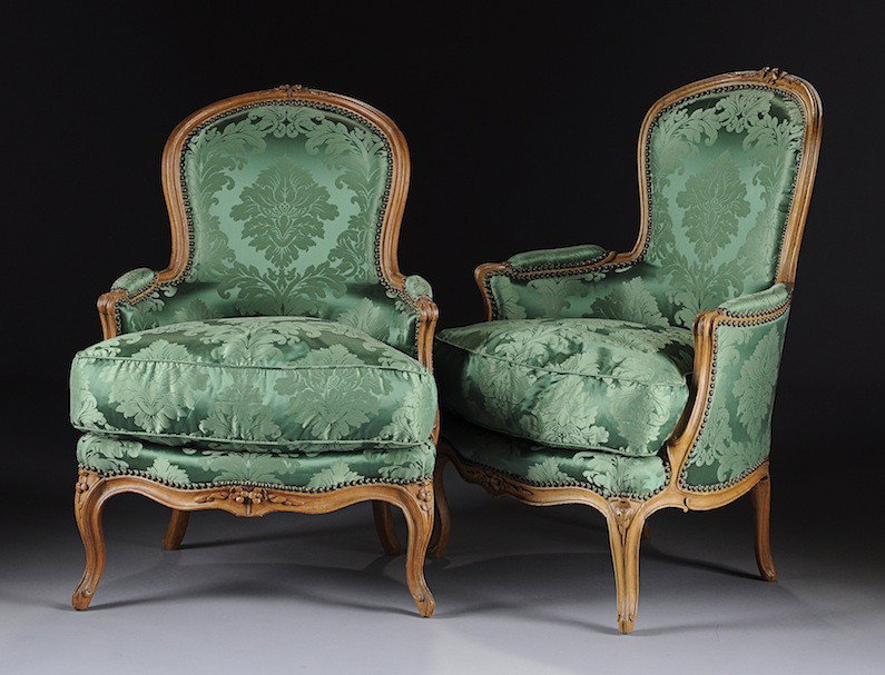 A PAIR OF LOUIS XV CARVED BEECHWOOD BERGéRES, EACH: A PAIR OF LOUIS XV CARVED BEECHWOOD BERGéRES, EACH STAMPED J.B.BOULARD, MID 18TH CENTURY, each detailed with an arched molded crest centering paired floral stems continuing to padded arms and sinuous
