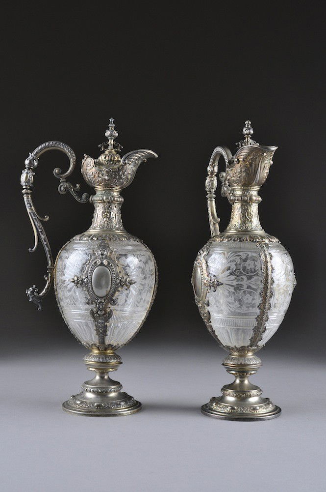 A PAIR OF GERMAN RENAISSANCE STYLE SILVER GILT AND: A PAIR OF GERMAN RENAISSANCE STYLE SILVER GILT AND SILVER MOUNTED ETCHED GLASS EWERS BY SCHURMANN, CIRCA 1900, each of ovoid form and centering an engraved monogram oval cartouche within a finely deta