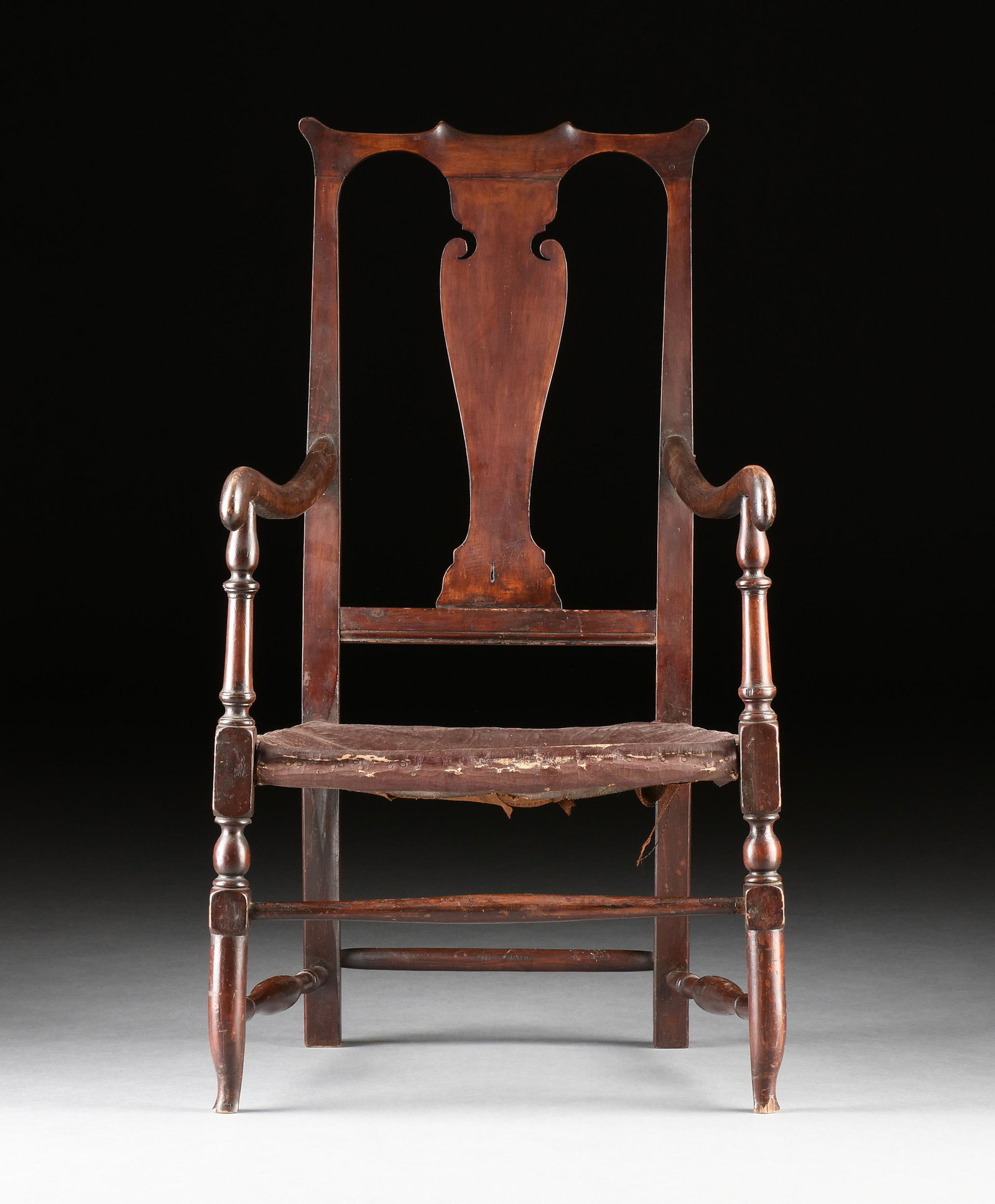 A WILLIAM & MARY ARMCHAIR, PROBABLY PENNSYLVANIA, 18TH CENTURY,: A WILLIAM & MARY ARMCHAIR, PROBABLY PENNSYLVANIA, 18TH CENTURY, finished throughout in a dark reddish brown stain, the double yoke crest rail with scalloped center above a contoured scrolling handled 