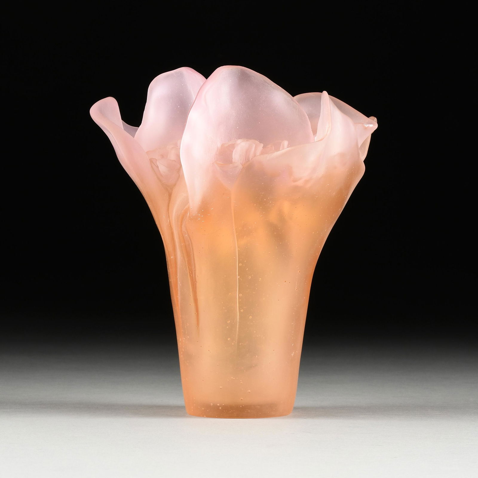 A DAUM PINK PÂTE DE VERRE FLORA FORM GLASS VASE, SIGNED, LATE 20TH CENTURY,: A DAUM PINK PÂTE DE VERRE FLORA FORM GLASS VASE, SIGNED, LATE 20TH CENTURY, in shades of pinkish orange, verso engraved "Daum France." Height: 9 1/2" Diameter: 8 3/4"