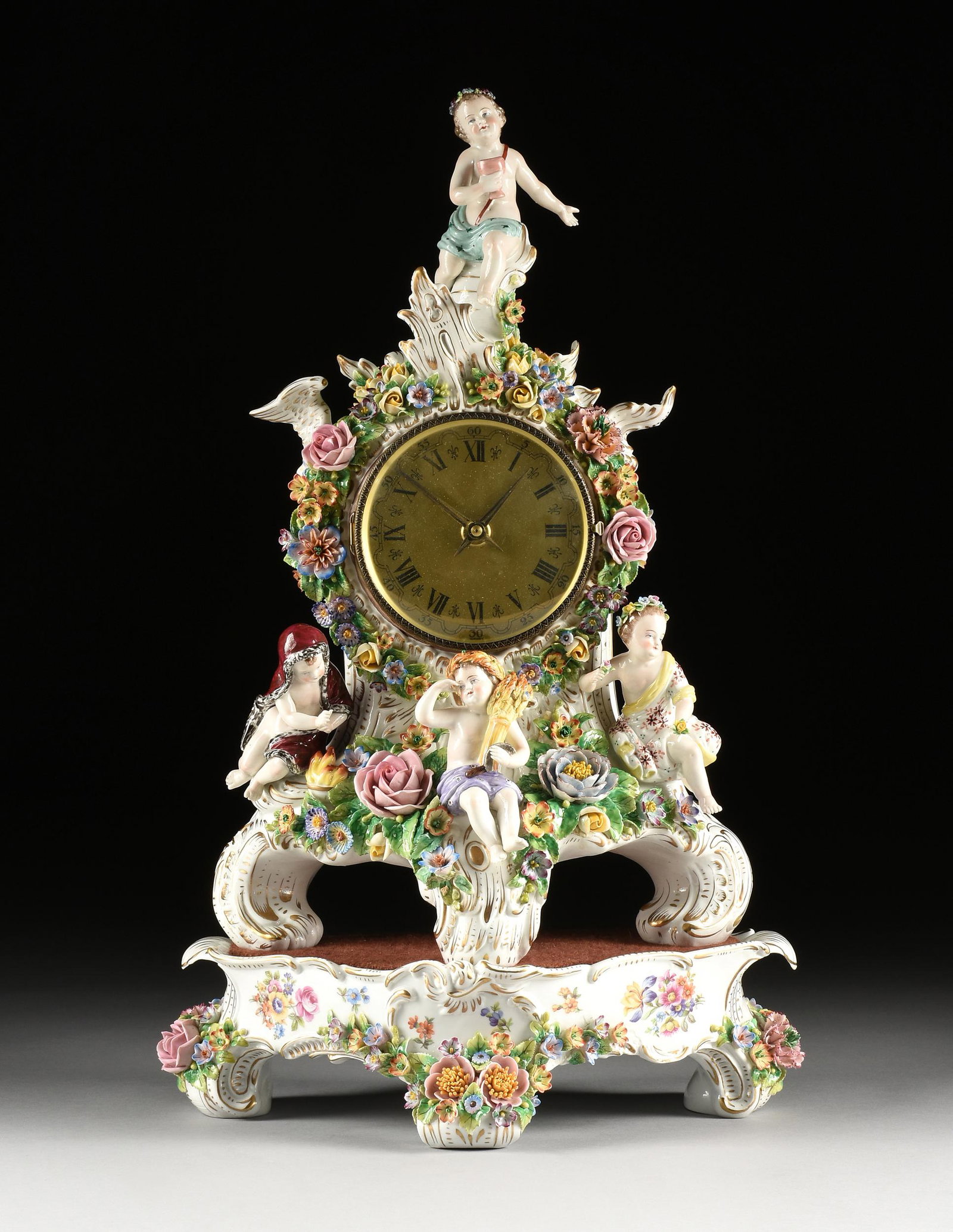 A SITZENDORF "FOUR SEASONS" FLORAL ENCRUSTED PORCELAIN CLOCK ON STAND, MARKED, GERMAN, LATE: A SITZENDORF "FOUR SEASONS" FLORAL ENCRUSTED PORCELAIN CLOCK ON STAND, MARKED, GERMAN, LATE 19TH/EARLY 20TH CENTURY, with a scantily robed putto representing Autumn and holding aloft a wine goblet whi