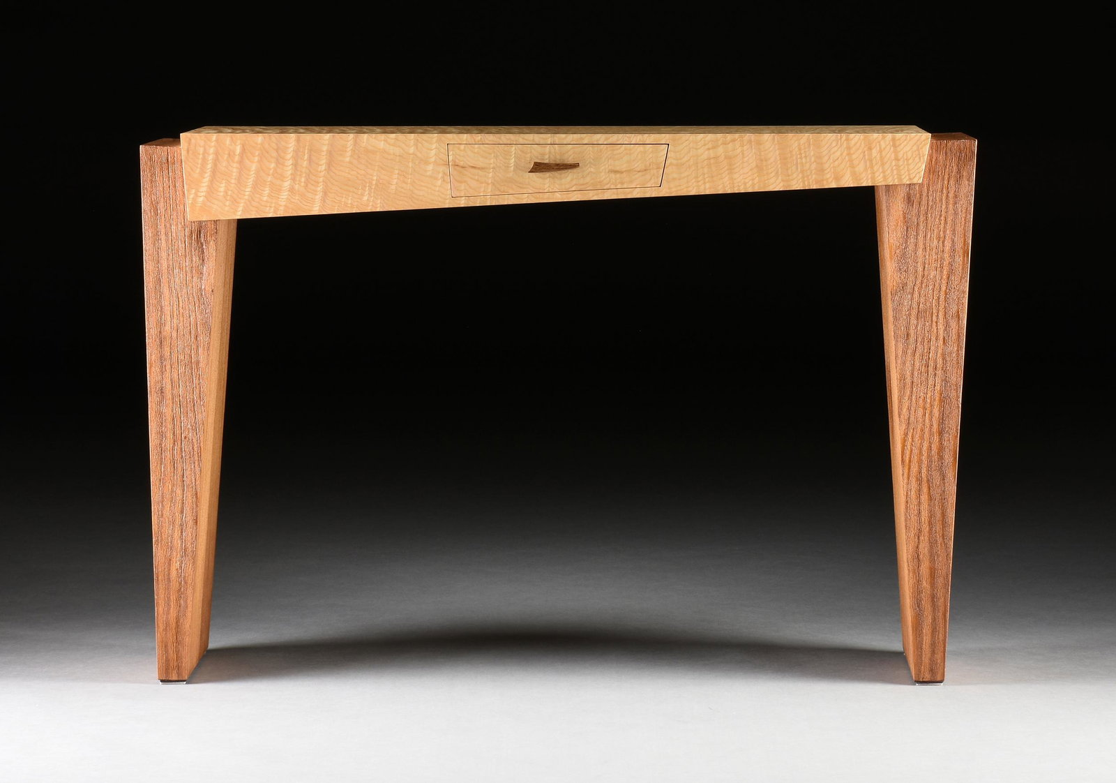 A CONTEMPORARY MIXED WOOD CONSOLE TABLE, AMERICAN, 2007,: A CONTEMPORARY MIXED WOOD CONSOLE TABLE, AMERICAN, 2007, indistinctly signed and dated 2007 on the underside, with a short front drawer. Height: 32'' Width: 48'' Depth: 14''