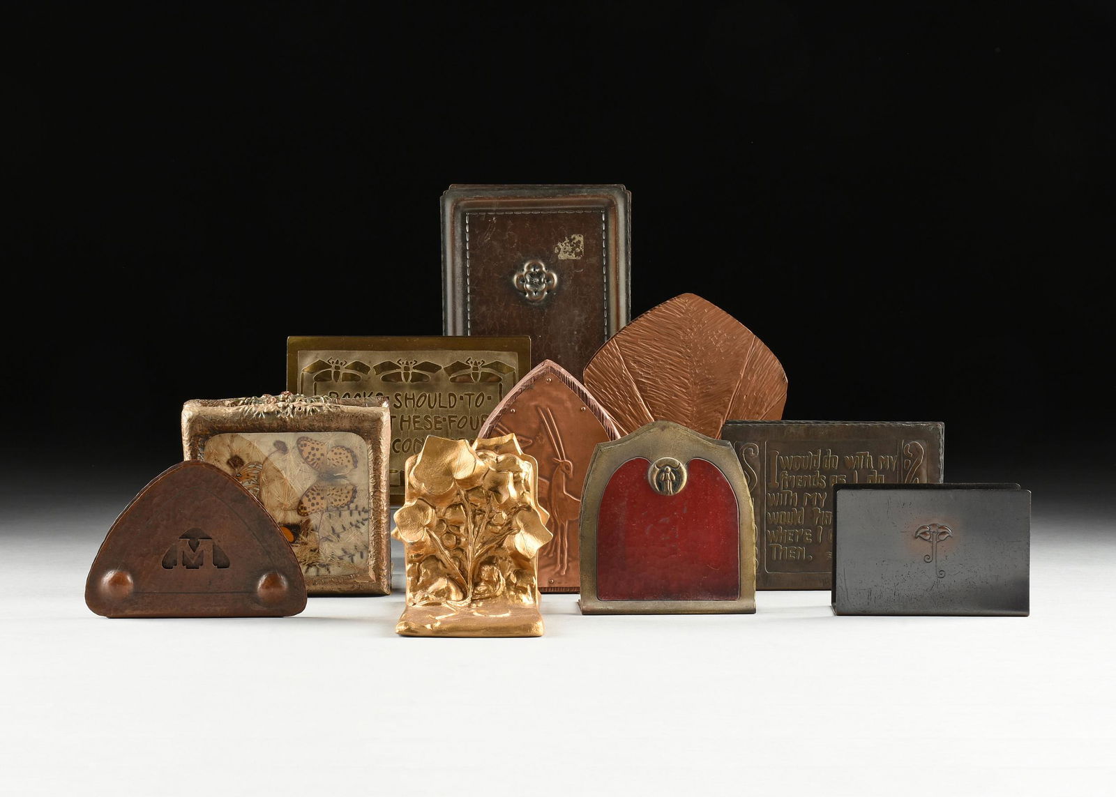 A GROUP OF NINE PAIRS OF BOOKENDS AND A LETTER HOLDER, AMERICAN, 20TH CENTURY,: A GROUP OF NINE PAIRS OF BOOKENDS AND A LETTER HOLDER, AMERICAN, 20TH CENTURY, comprising a pair of bookends made of gessoed and painted wood with preserved butterflies under glass; a pair of copper&#
