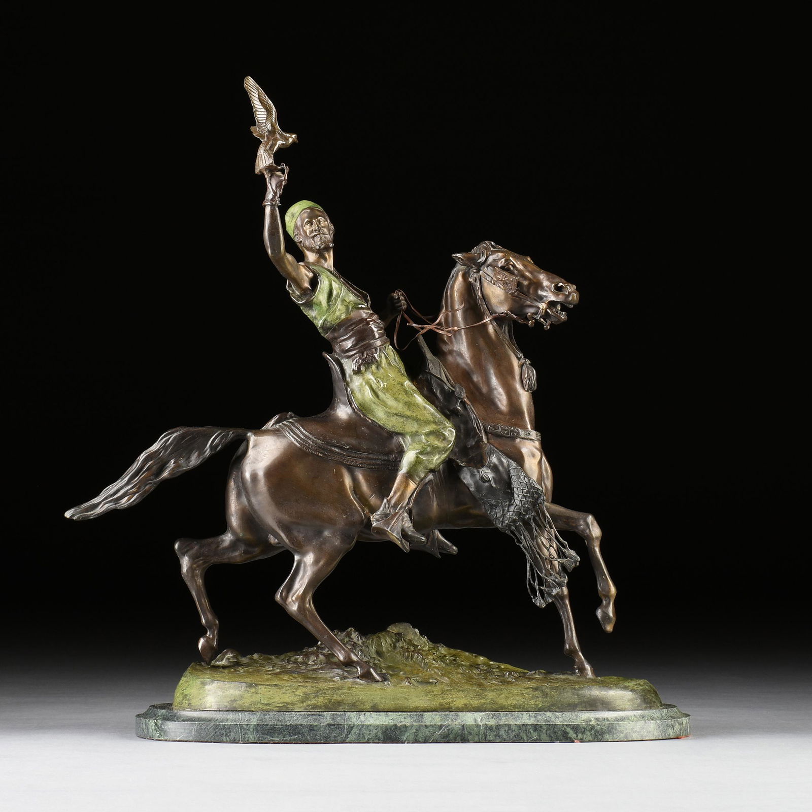 after PIERRE JULES MENE (French 1810-1879) A SCULPTURE, "The Arab Falconer on Horseback," 20TH: after PIERRE JULES MENE (French 1810-1879) A SCULPTURE, "The Arab Falconer on Horseback," 20TH CENTURY, parcel gilt and green cold painted on brown patinated cast bronze, raised on an oval green marbl