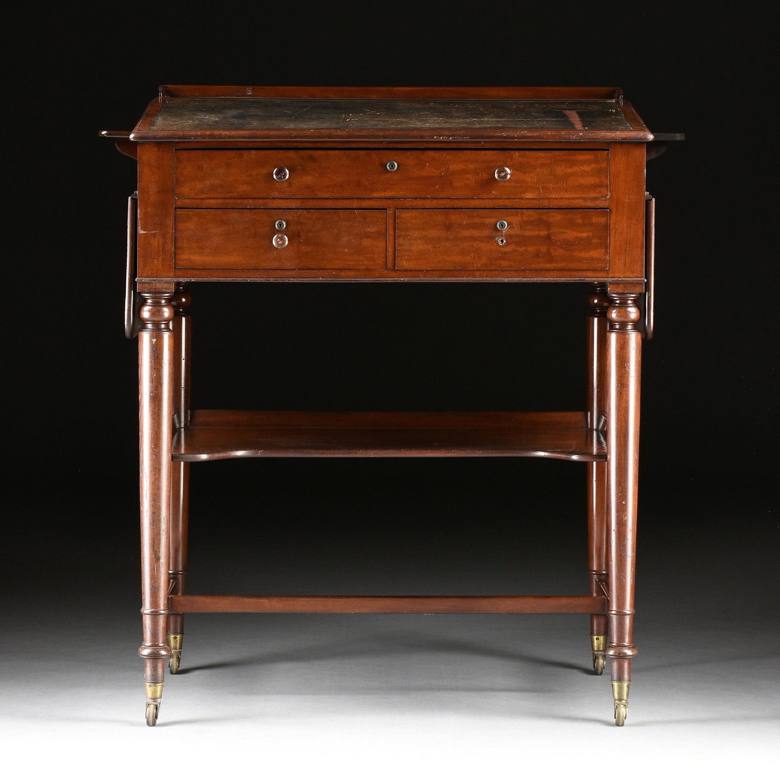 A GEORGE III FLAME MAHOGANY DRAFTING DESK, EARLY 19TH CENTURY,: A GEORGE III FLAME MAHOGANY DRAFTING DESK, EARLY 19TH CENTURY, the three quarter gallery back board top above a slanted panel centering an inset black leather writing surface, over one long drawer abo