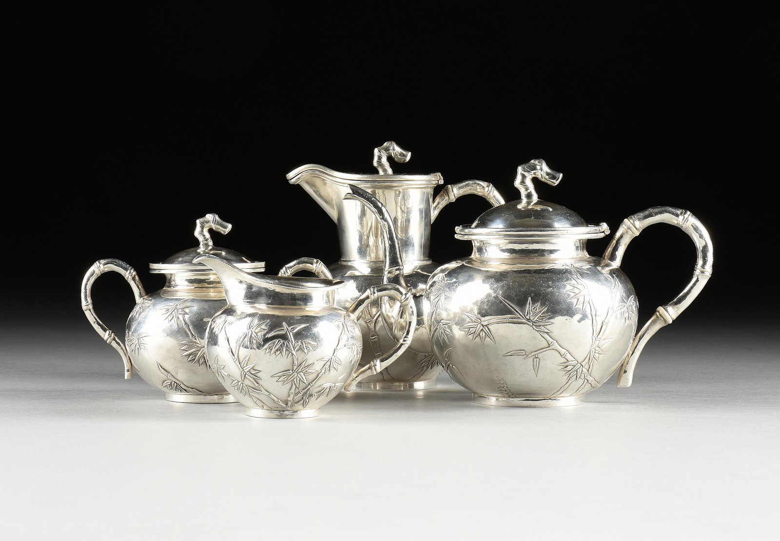 A CHINESE EXPORT FOUR PIECE "BAMBOO" REPOUSSÉ SILVER TEA SET, BY HUNG CHONG & CO, STAMPED,: A CHINESE EXPORT FOUR PIECE "BAMBOO" REPOUSSÉ SILVER TEA SET, BY HUNG CHONG & CO, STAMPED, SHANGHAI, CIRCA 1900, each piece decorated with a hammered surface and leafy bamboo stalks with bamboo f