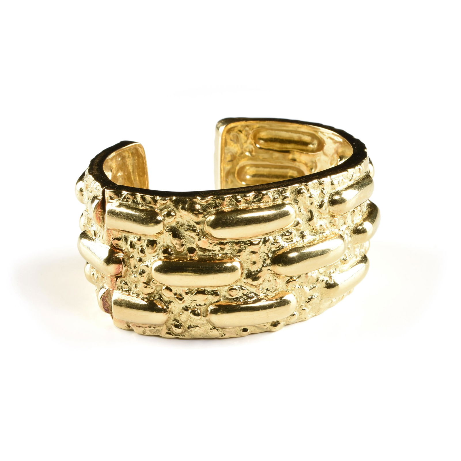 A DAVID WEBB 18K YELLOW GOLD CUFF BRACELET, CIRCA 1989,: A DAVID WEBB 18K YELLOW GOLD CUFF BRACELET, CIRCA 1989, a nugget style texture ground with rows of highly polished "stitched" lozenge relief in rows, wing hinge stamped, "©WEBB® 18