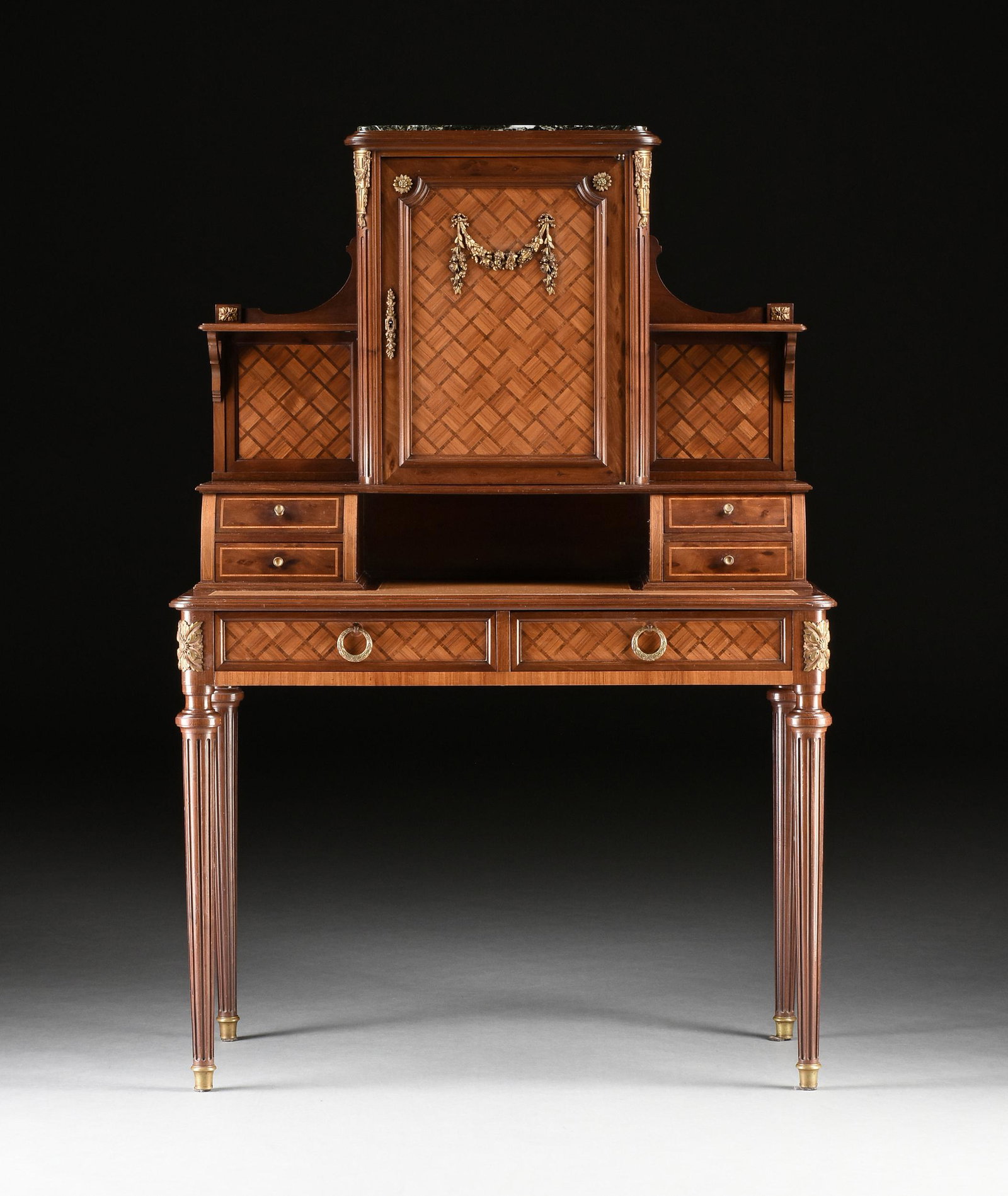 A LOUIS XVI REVIVAL ORMOLU MOUNTED ACAJOU MOUCHETÉ AND TULIP WOOD PARQUETRY BONHEUR DU JOUR,: A LOUIS XVI REVIVAL ORMOLU MOUNTED ACAJOU MOUCHETÉ AND TULIP WOOD PARQUETRY BONHEUR DU JOUR, PARIS, LATE 19TH/EARLY 20TH CENTURY, with a central rectangular cabinet surmounted by a vert de Maurin