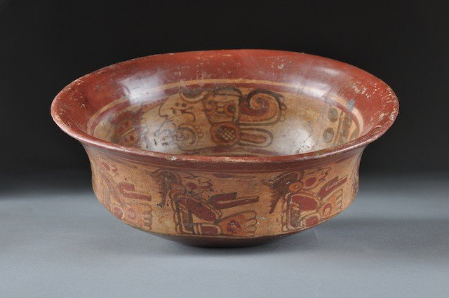 A PRE-COLUMBIAN MAYAN COPAN POLYCHROME BOWL, 600-9: A PRE-COLUMBIAN MAYAN COPAN POLYCHROME BOWL, 600-900 A.D., the sides painted a continuous band of warrior silhouettes with conforming interior decorated burnt orange on a cream slip. Height: 3 1/2" Di