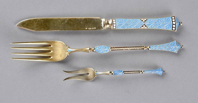 A THIRTY-SIX PIECE SCANDINAVIAN SILVER-GILT AND TU: A THIRTY-SIX PIECE SCANDINAVIAN SILVER-GILT AND TURQUOISE ENAMELED CLOISONNÉ FRUIT SET, POSSIBLY FINNISH, 20TH CENTURY, each piece having a triangular banner top enclosing beaded scrolling decoration