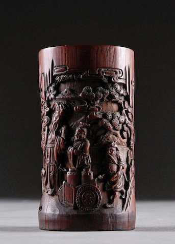 AN ANTIQUE CHINESE CARVED BAMBOO BRUSH POT, 19TH C: AN ANTIQUE CHINESE CARVED BAMBOO BRUSH POT, 19TH CENTURY, carved in relief and depicting a sage in long flowing robes and holding a ruyi scepter with attendants set amidst ancient pines and foliage in