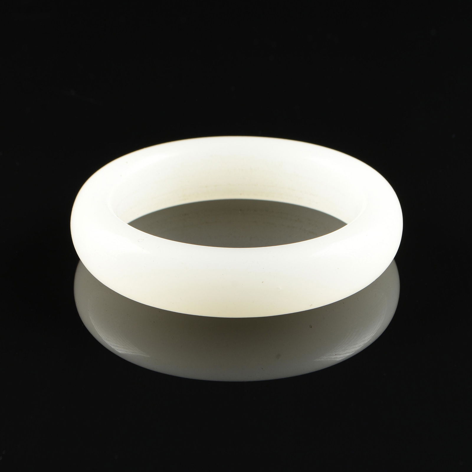 A CHINESE WHITE JADE BANGLE, 20TH CENTURY, (1 of 2)