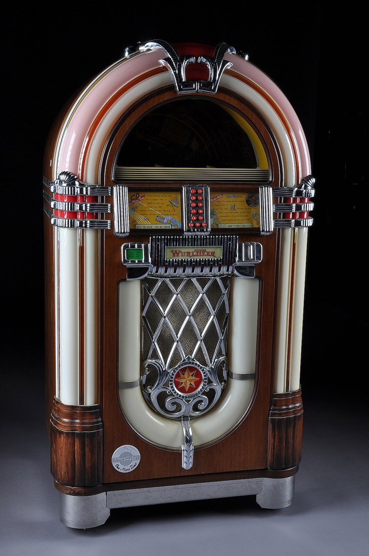 A WURLITZER 1015 SPECIAL EDITION "ONE MORE TIME" JUK: A WURLITZER 1015 SPECIAL EDITION "ONE MORE TIME" JUKE BOX designed by Paul Fuller, coin operated, plays fifty CD's, made in Germany. Height: 60" Width: 32" Depth: 23"
