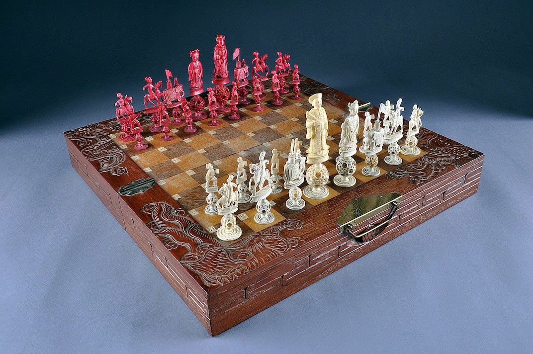 A CHINESE EXPORT FIGURAL IVORY CHESS SET, LATE 19T: A CHINESE EXPORT FIGURAL IVORY CHESS SET, LATE 19TH CENTURY, each piece carved standing on the Chu of Pao Pao, on circular base. Height of kings: 5"; the players, both stained red and natural, modeled