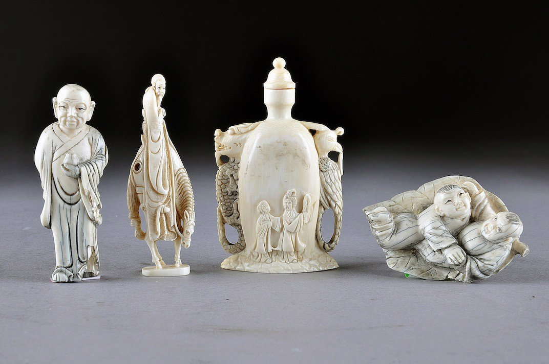 A GROUP OF ANTIQUE AND VINTAGE JAPANESE IVORY CARV: A GROUP OF ANTIQUE AND VINTAGE JAPANESE IVORY CARVINGS comprising a netsuke of two playful youths naturalistically detailed on a leaf reversing to a two character mark signature, small chip, length: 2