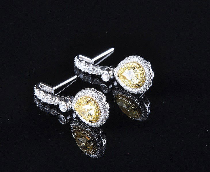 A PAIR OF PLATINUM & 18K FANCY YELLOW DIAMOND LADY: A PAIR OF PLATINUM & 18K FANCY YELLOW DIAMOND LADYÕS EARRINGS BY CHARLES KRYPELL, drop styling set with one pear shape diamond = 1.03 Cts., Color Grade Ð Fancy Yellow, Clarity Grade Ð SI1, (Gemolog