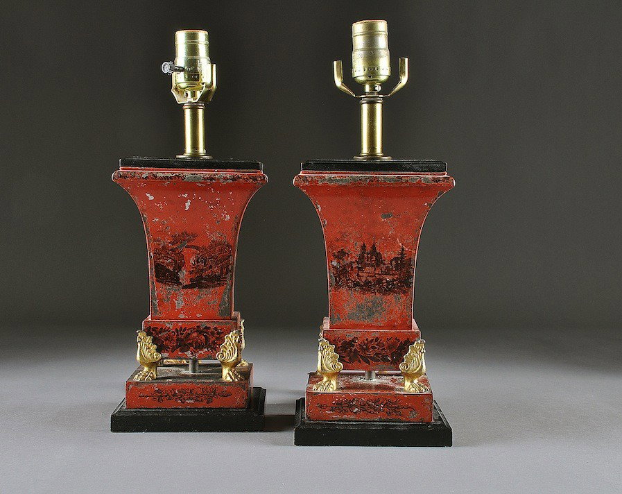 A PAIR OF EARLY VICTORIAN RED TOLE PAINTED AND BLA: A PAIR OF EARLY VICTORIAN RED TOLE PAINTED AND BLACK STENCILED VASES, CIRCA 1850, each of flaring square form and centering romantic views of castle ruins above a base enclosing a continuous band of b