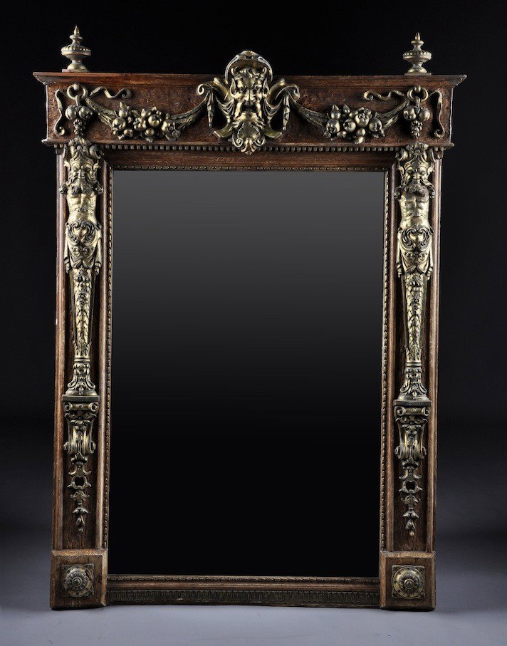 A LOUIS XIV STYLE PARCEL GILT CARVED WOOD AND COMP: A LOUIS XIV STYLE PARCEL GILT CARVED WOOD AND COMPOSITION MANTLE MIRROR, SECOND HALF 19TH CENTURY, the rectangular mirror surmounted by a cavetto molded cornice above a frieze centering a bearded saty