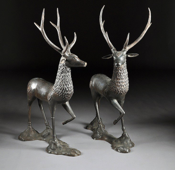 A PAIR OF ASIAN PATINATED CAST BRONZE GARDEN FIGUR: A PAIR OF ASIAN PATINATED CAST BRONZE GARDEN FIGURES OF STAGS, LATE 20TH CENTURY, each naturalistically modeled in a standing position with turned head beneath a 6 point antler spread flanking an appl