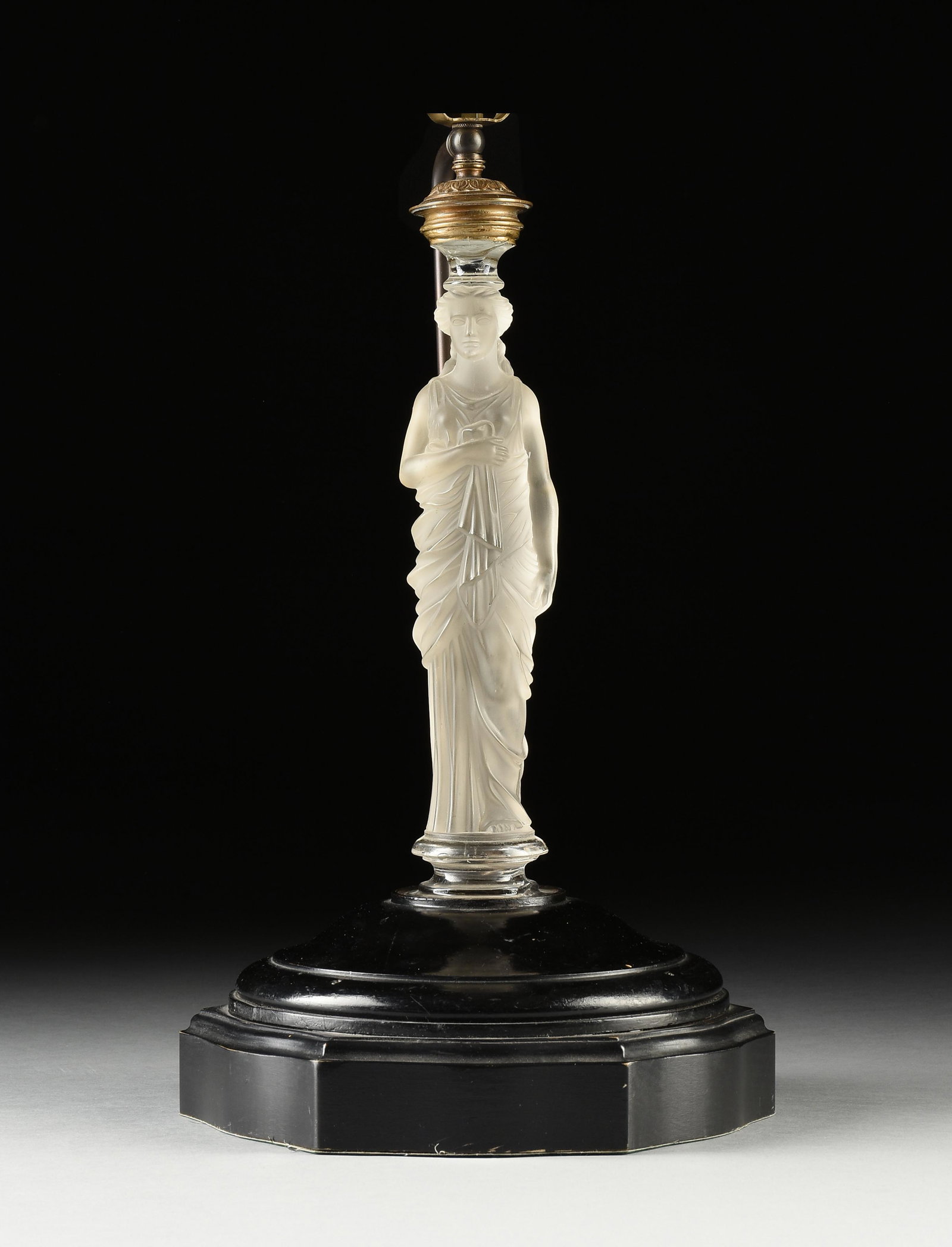 A TABLE LAMP WITH FROSTED GLASS FIGURE OF A MAIDEN, PROBABLY BACCARAT, 20TH CENTURY,: A TABLE LAMP WITH FROSTED GLASS FIGURE OF A MAIDEN, PROBABLY BACCARAT, 20TH CENTURY, frosted glass central figure on a black wooden stand, with metal support rod for cord and metal fittings for bulb, 