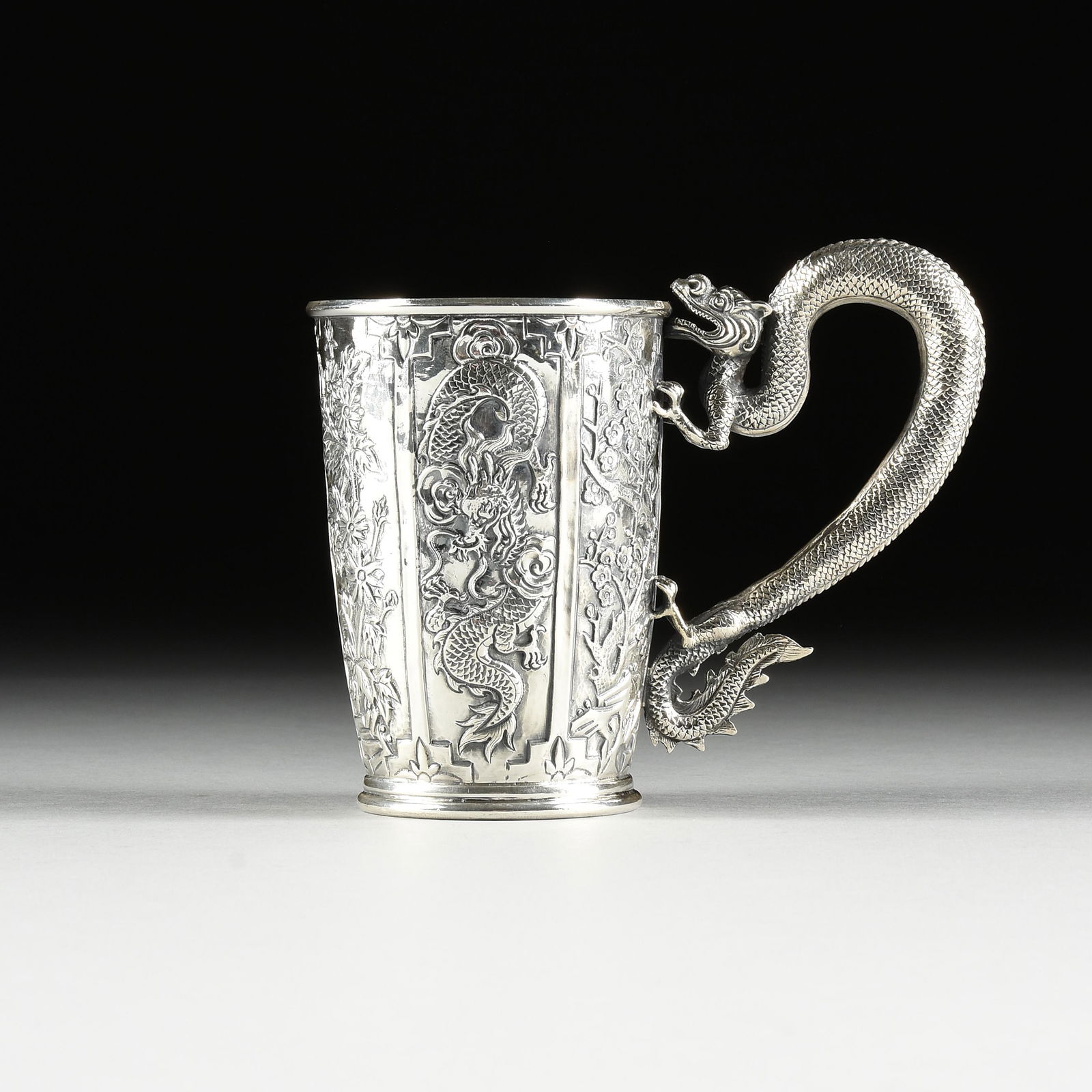 A CHINESE EXPORT SILVER REPOUSSÉ DRAGON MUG, ATTRIBUTED TO TIEN SHANG, PROBABLY HONG KONG, 1870 (1 of 10)