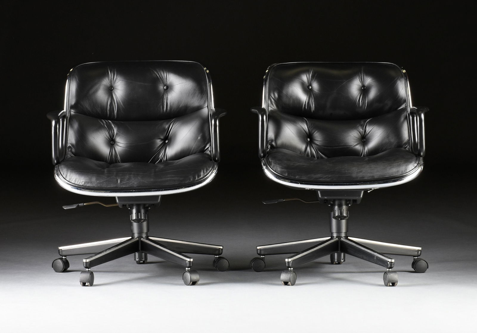 SEVEN KNOLL "POLLOCK" BLACK LEATHER EXECUTIVE ARMCHAIRS, MODERN,: SEVEN KNOLL "POLLOCK" BLACK LEATHER EXECUTIVE ARMCHAIRS, MODERN, original design by Charles Pollock in 1963, aluminum band construction on casters, underside with Knoll manufacturing labels. Height: 3