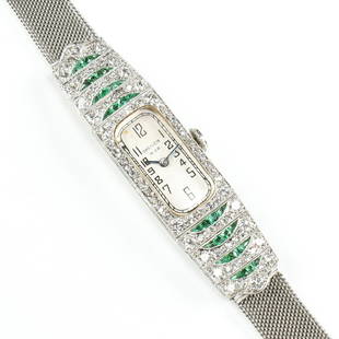 A PLATINUM, EMERALD AND DIAMOND DREICER & CO. ART DECO WATCH,: A PLATINUM, EMERALD AND DIAMOND DREICER & CO. ART DECO WATCH, the bezel and upper portion of the band are set with approximately 143 single cut and full cut diamonds, color: H-J, clarity: VS-SI, combi