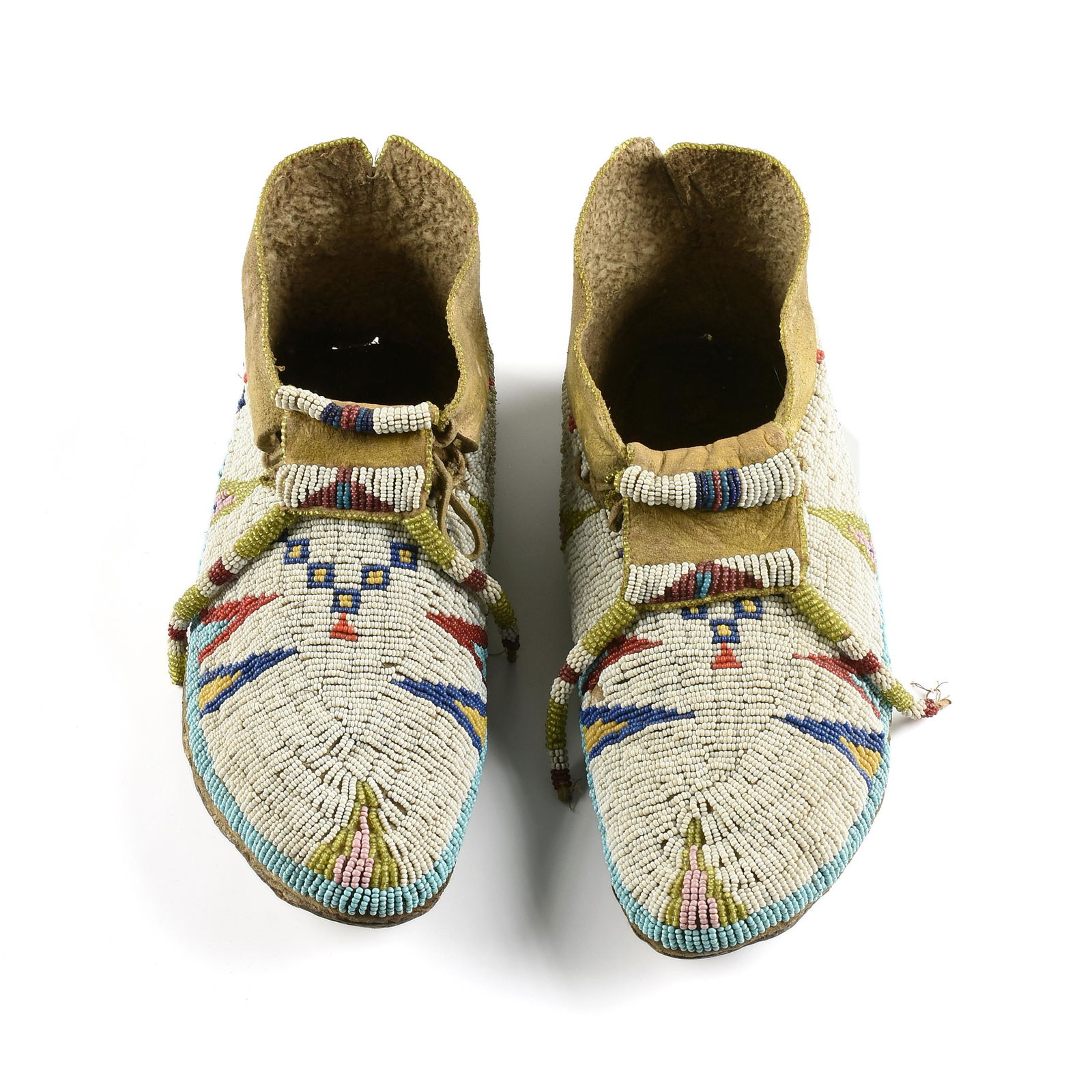 A PAIR OF NATIVE AMERICAN PLAINS INDIANS BEADED LEATHER MOCCASINS, PROBABLY CHEYENNE, 20TH CENTURY, (1 of 5)