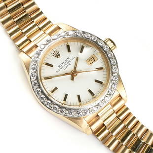 AN 18K GOLD AND DIAMOND LADY'S ROLEX OYSTER PERPETUAL DATE WRISTWATCH,: AN 18K GOLD AND DIAMOND LADY'S ROLEX OYSTER PERPETUAL DATE WRISTWATCH, with fixed circular diamond bezel, clasp marked, "ROLEX / GENEVE / SWISSMADE / 18K," and with the numbers, "8570," and "750," tot