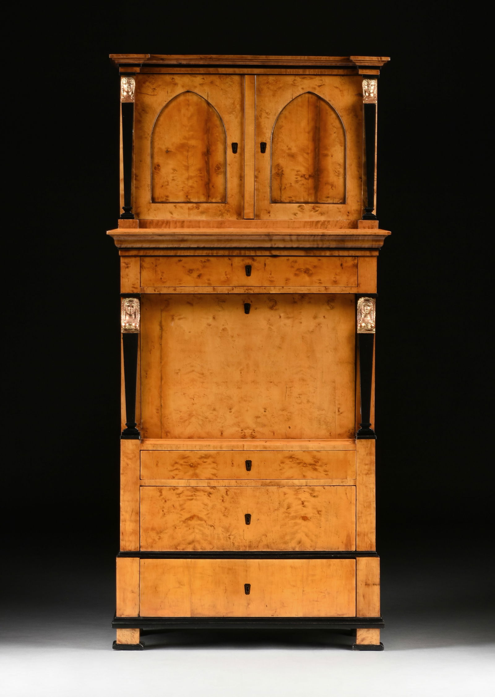 A BIEDERMEIER PARCEL-GILT AND EBONIZED WOOD KARELIAN BIRCH FALL FRONT SECRETARY, CIRCA 1810, (1 of 20)