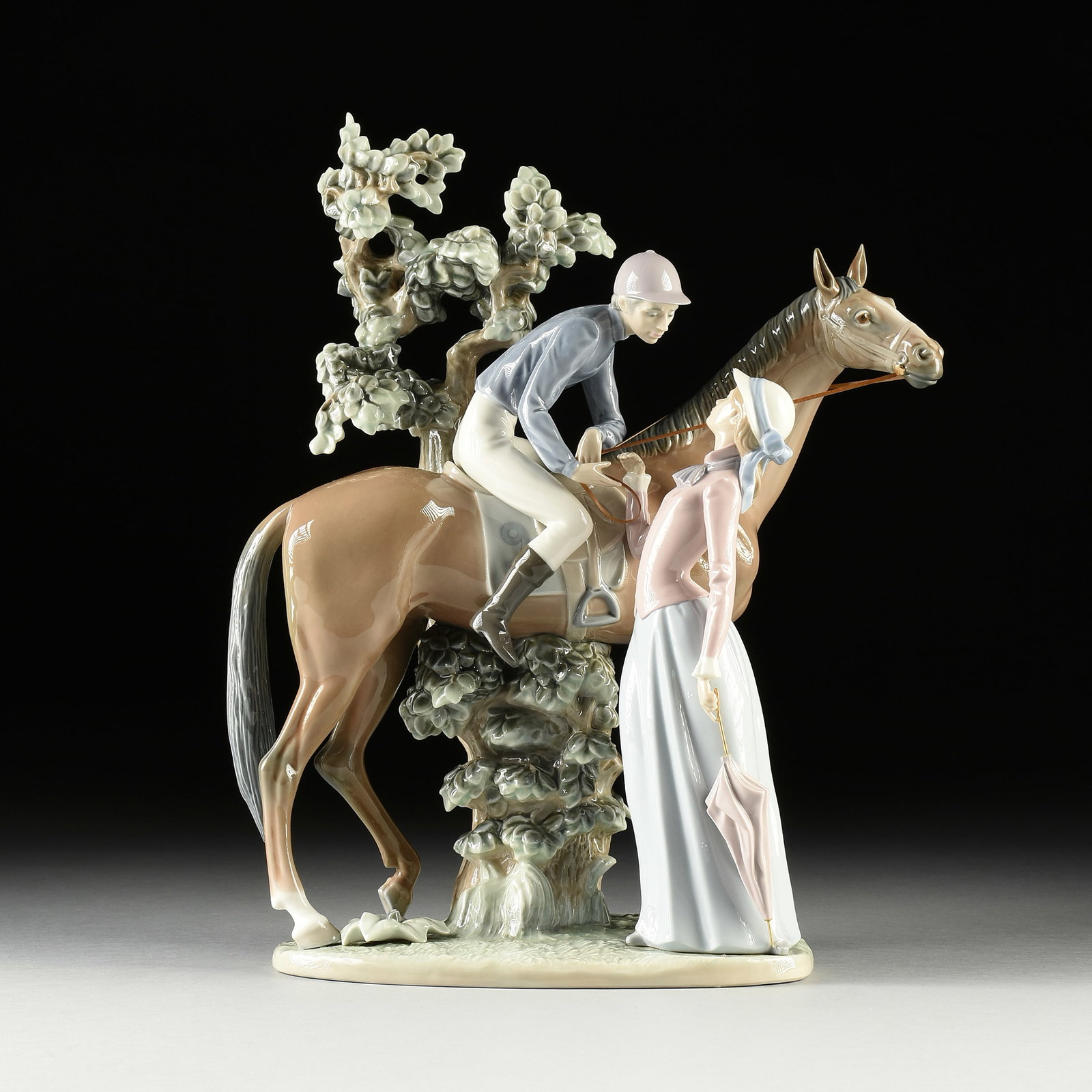 A LLADRÓ PORCELAIN FIGURAL GROUP, "Jockey and Lass," 1979-2000,: A LLADRÓ PORCELAIN FIGURAL GROUP, "Jockey and Lass," 1979-2000, model #5036, with the blue Lladró stamp at base; approximately 11" x 26" x 10".