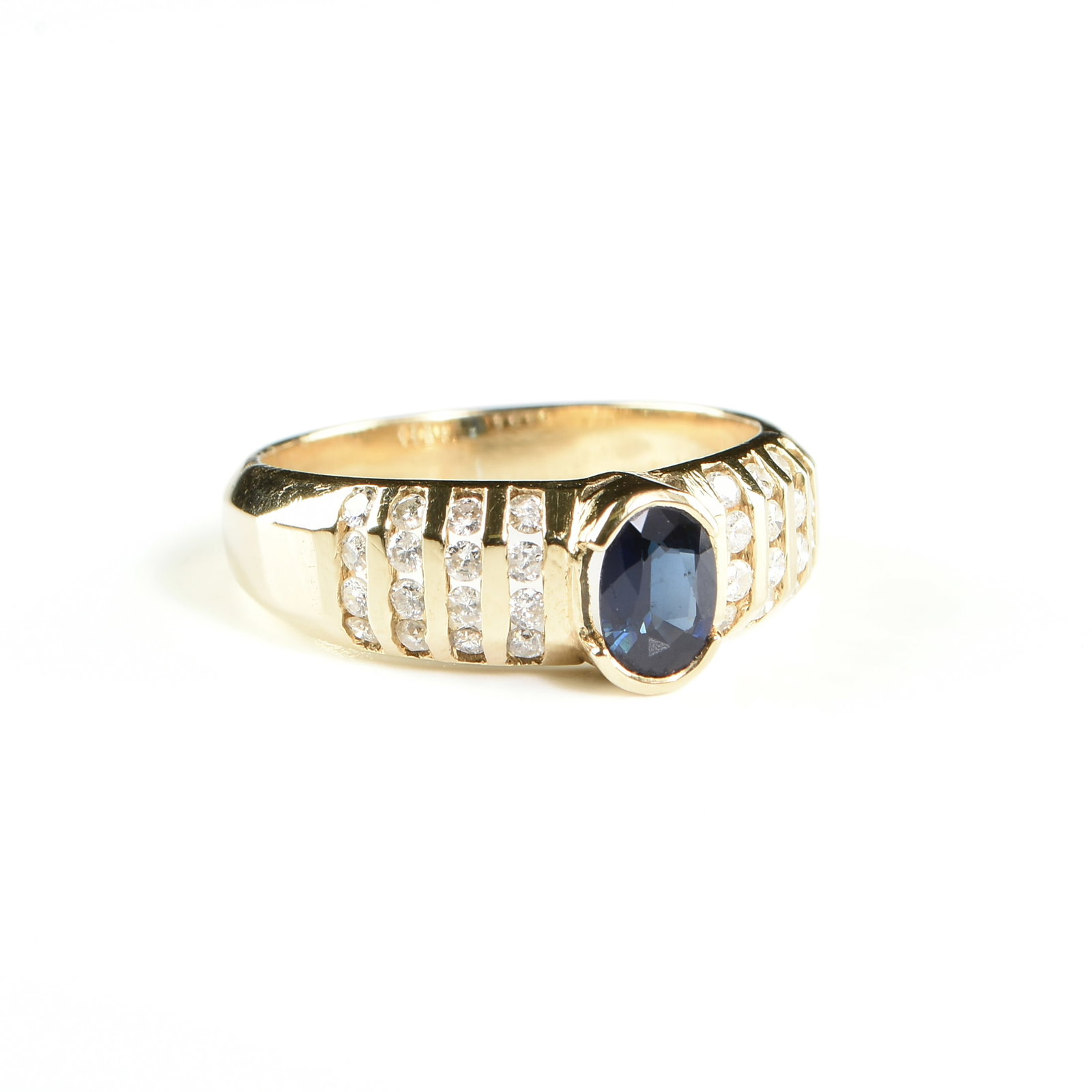 A 14K YELLOW GOLD, SAPPHIRE, AND DIAMOND RING,: A 14K YELLOW GOLD, SAPPHIRE, AND DIAMOND RING, with a central bezel set oval sapphire, color: slightly greenish blue, clarity: slightly included, approximate weight: 0.40 ct., flanked by thirty-two ro