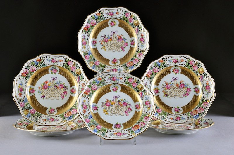 A SET OF SIX DRESDEN PARCEL GILT AND POLYCHROME PA: A SET OF SIX DRESDEN PARCEL GILT AND POLYCHROME PAINTED RETICULATED PLATES, CARL THIEME FACTORY, POTSCHAPPEL, CIRCA 1918, each with a waved double line rim enclosing "C" scroll molded panels of traili