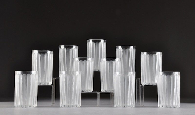 A SET OF ELEVEN LALIQUE CRYSTAL TUMBLERS, JAFFA PA: A SET OF ELEVEN LALIQUE CRYSTAL TUMBLERS, JAFFA PATTERN, ORIGINALLY DESIGNED IN 1931, each of traditional frosted and transparent decoration, with engraved "Lalique R France" on underside (11). Height