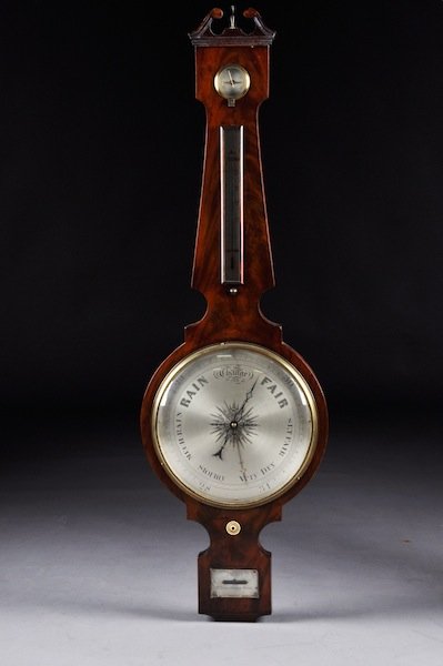 A VICTORIAN FLAME MAHOGANY THERMOMETER BAROMETER W: A VICTORIAN FLAME MAHOGANY THERMOMETER BAROMETER WALL INSTRUMENT BY J. SCOTT, 17 BERMONDSEY WALL, MID 19TH CENTURY, the scrolling broken pediment crest above a rectangular capital enclosing an inset d
