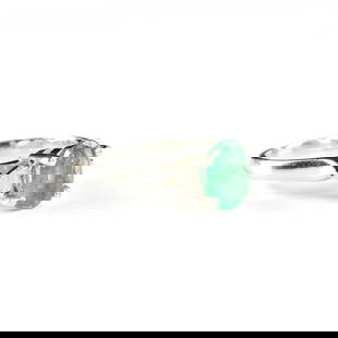 A 14K WHITE GOLD, DIAMOND, AND COLOMBIAN EMERALD RING, LATE 20TH CENTURY: A 14K WHITE GOLD, DIAMOND, AND COLOMBIAN EMERALD RING, LATE 20TH CENTURY, the central faceted oval cut green Colombian emerald measures approximately 6.14 mm x 8.16 mm with an approximate weight of .4