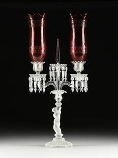 A BACCARAT CRYSTAL CANDELABRA WITH ETCHED CRANBERRY GLASS SHADES, SIGNED, FRENCH, 20TH CENTURY: A BACCARAT CRYSTAL CANDELABRA WITH ETCHED CRANBERRY GLASS SHADES, SIGNED, FRENCH, 20TH CENTURY, two petal edge cranberry shades with geometric etched details rest in floriform candle cups over prism-h