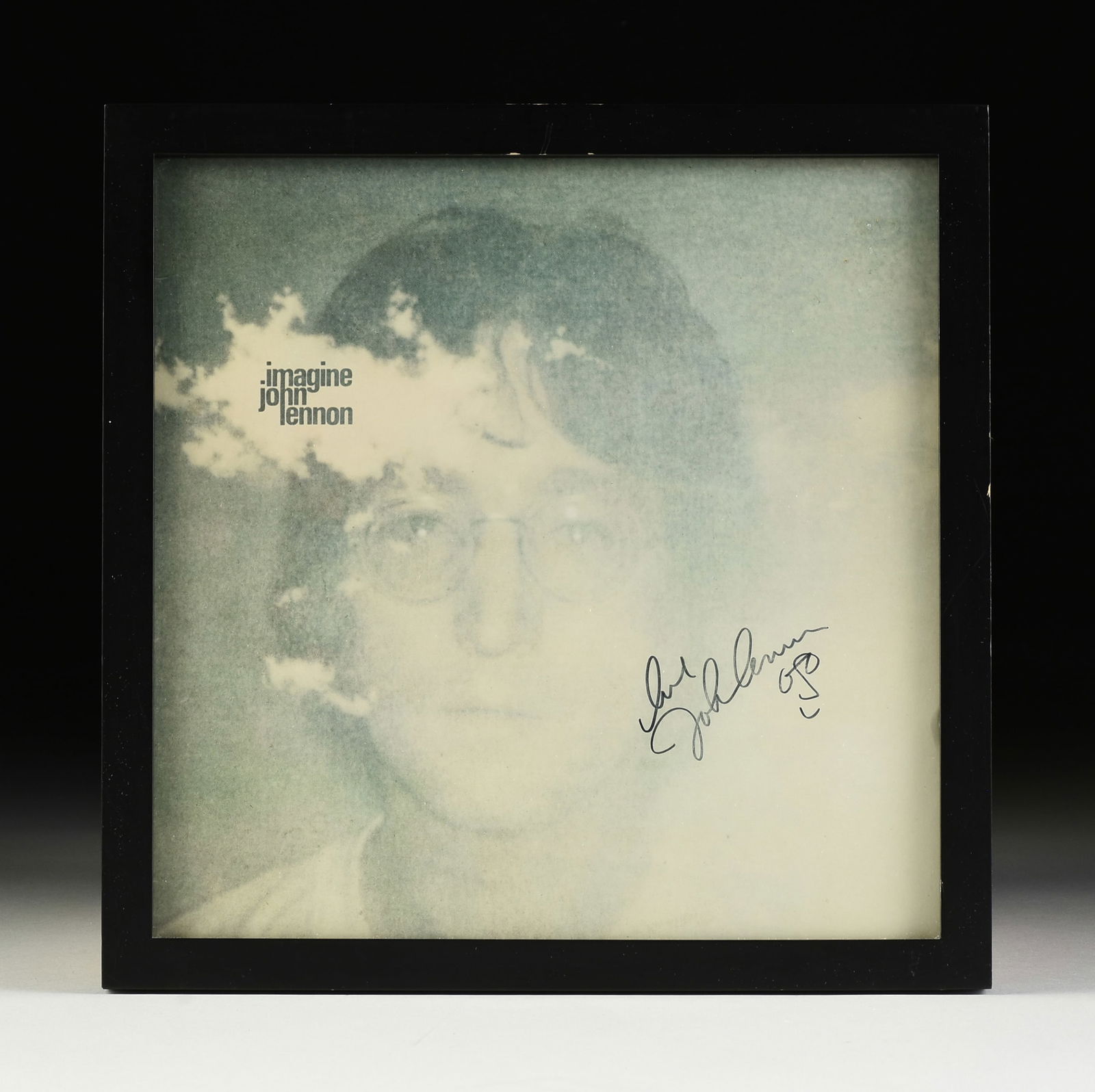 JOHN LENNON (British 1940-1980) A SIGNED ALBUM WITH A DOODLE, "Imagine," CIRCA 1971,: JOHN LENNON (British 1940-1980) A SIGNED ALBUM WITH A DOODLE, "Imagine," CIRCA 1971, autographed on the album cover, "love / John Lennon," and with Lennon's hand-drawn doodle of himself; framed 13 3/4