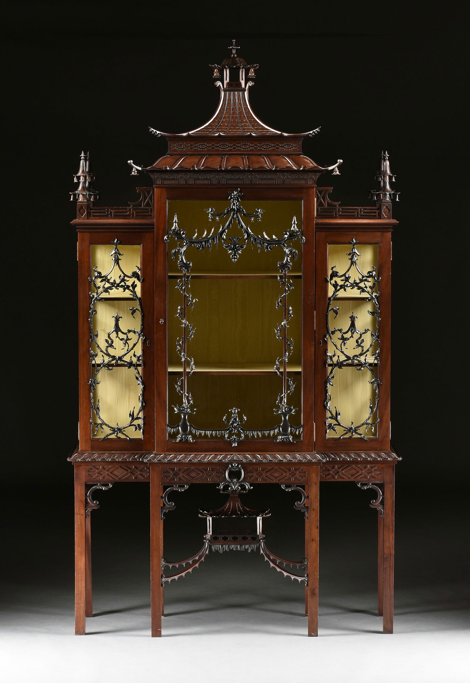 after THOMAS CHIPPENDALE (1718-1779) A CHINESE CHIPPENDALE MAHOGANY "CHINA CASE," ENGLISH,: after THOMAS CHIPPENDALE (1718-1779) A CHINESE CHIPPENDALE MAHOGANY "CHINA CASE," ENGLISH, 1870s-1900s, in the traditional 18th century chinoiserie taste, composed of mahogany, buttery yellow moire si