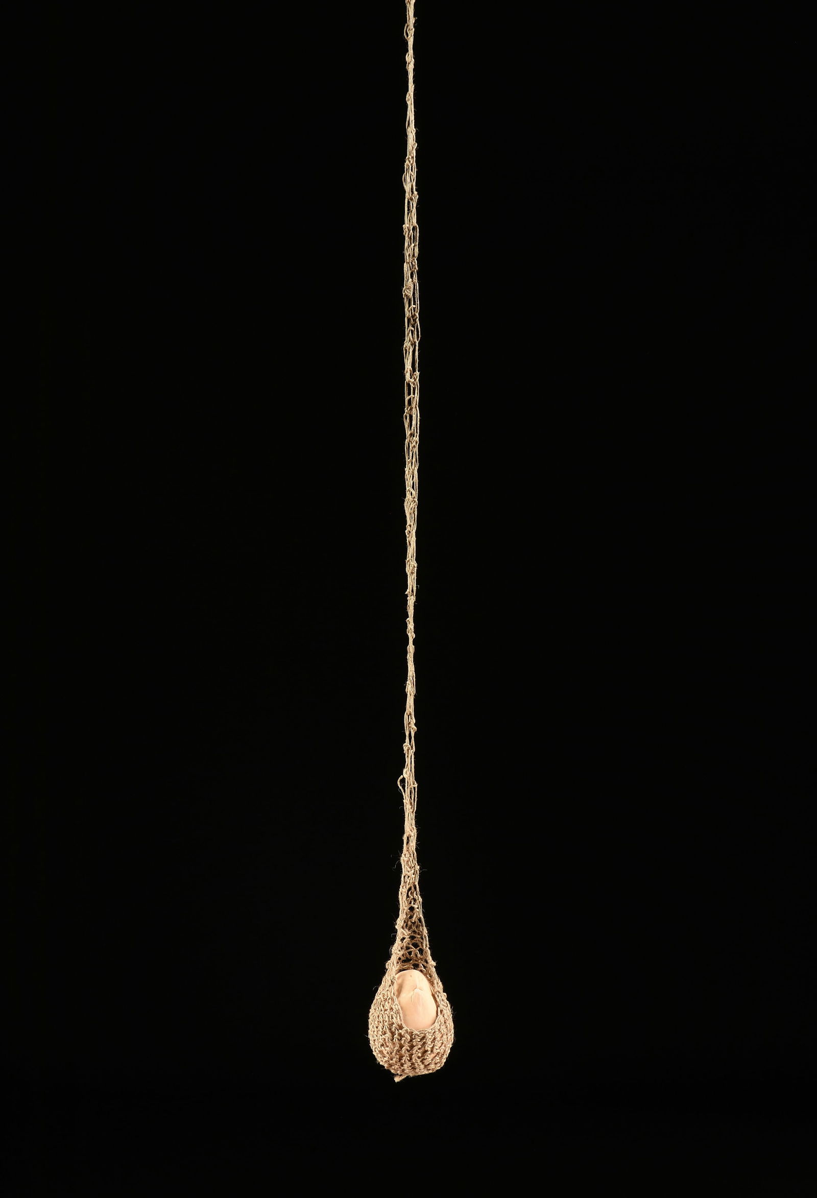 ERNESTO NETO (Brazilian b. 1964) A SCULPTURE, "We Are All Children of the Earth," 2018,: ERNESTO NETO (Brazilian b. 1964) A SCULPTURE, "We Are All Children of the Earth," 2018, crochet bag with a plaster mango, a strip of cloth attached to the bag has the artist's printed name, title and