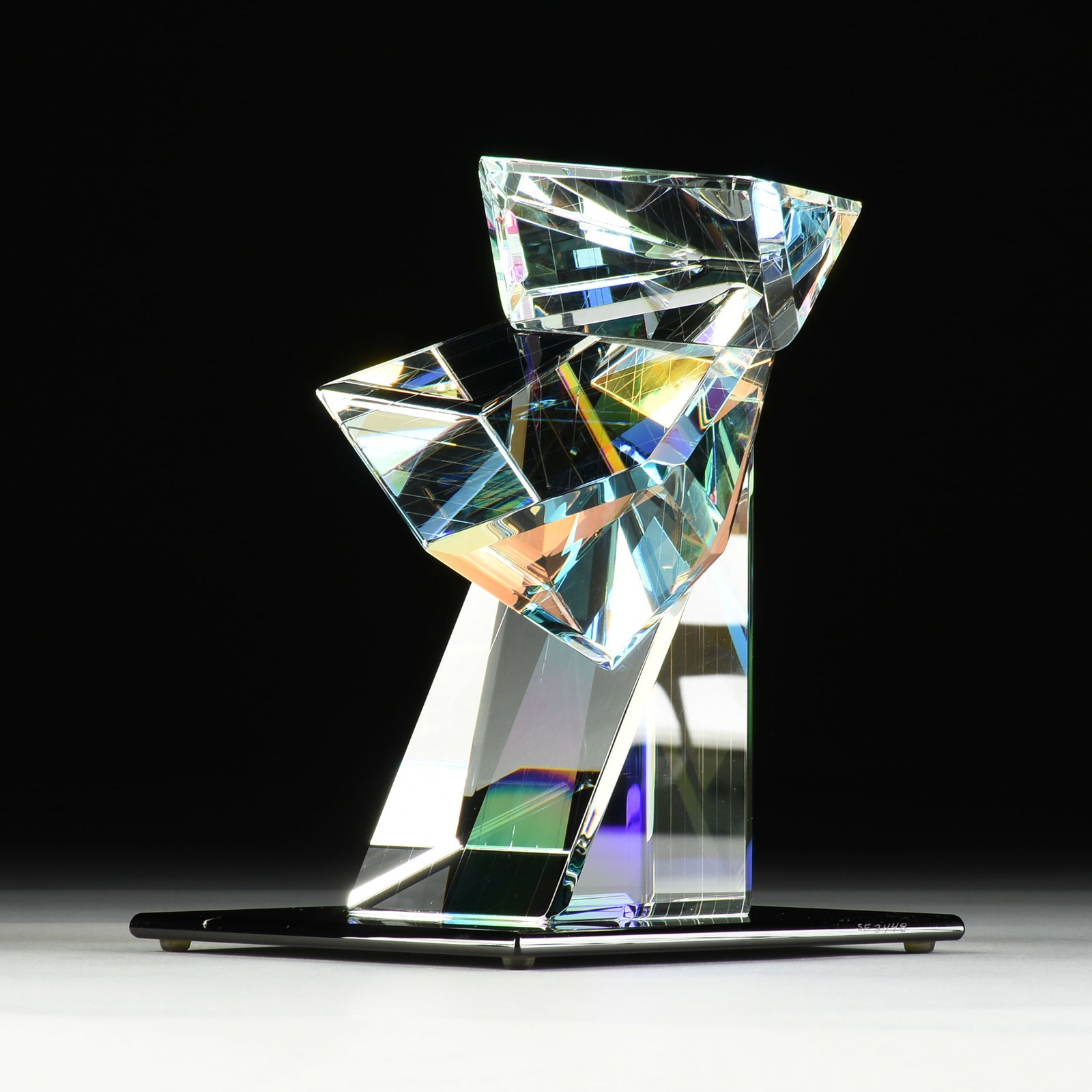 CONCETTA MASON (American b. 1952) A SCULPTURE, "Juggler's Charm," CIRCA 2000,: CONCETTA MASON (American b. 1952) A SCULPTURE, "Juggler's Charm," CIRCA 2000, clear glass sculpture on a black glass stand, signed at the base, "Concetta Mason," and titled, "Juggler's Charm," also in