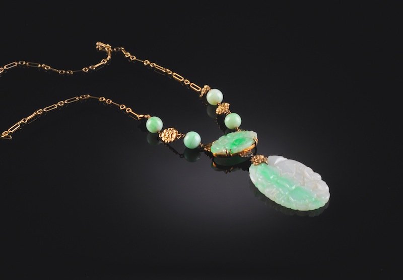 A VINTAGE CHINESE TWO PENDANT APPLE GREEN JADEITE A: A VINTAGE CHINESE TWO PENDANT APPLE GREEN JADEITE AND 14KT GOLD NECKLACE, 20TH CENTURY, the delicate reed and ball gold wire chain ending in apple green jadeite beads partitioned by stylized gold blos