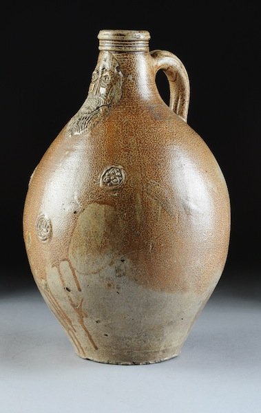 AN UNUSUALLY LARGE SALT GLAZED STONEWARE BELLARMIN: AN UNUSUALLY LARGE SALT GLAZED STONEWARE BELLARMINE JUG (RHENISH WARE), 17TH CENTURY, the neck embellished with a bearded face or mask, a caricature of Cardinal Bellamino, the Roman Catholic theologia